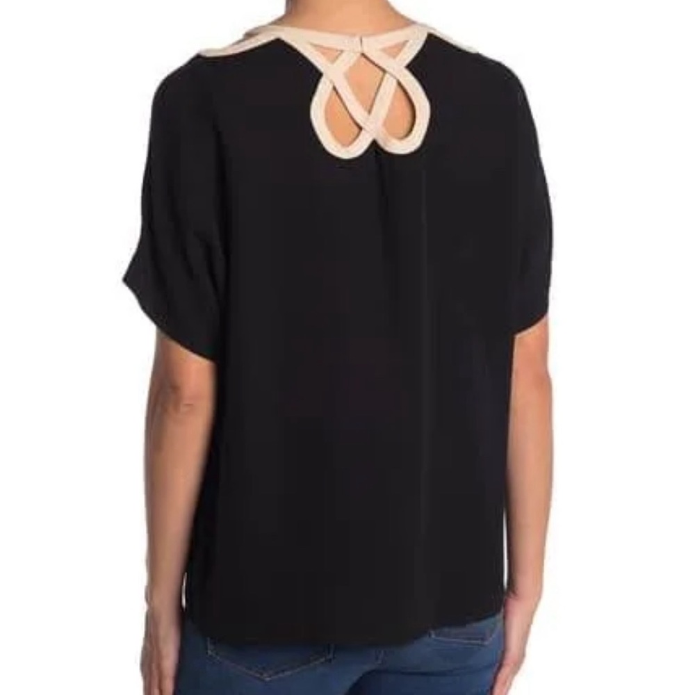 Black Diane Von Furstenberg blouse with ornate neckline